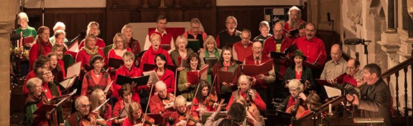 Group performing, dressed in red and green