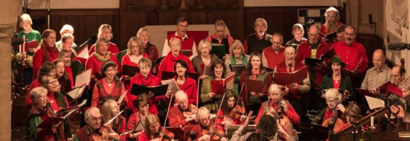 Group performing, dressed in red and green.