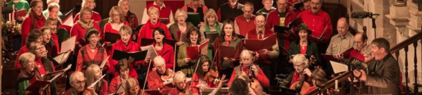 Group performing, dressed in red and green.