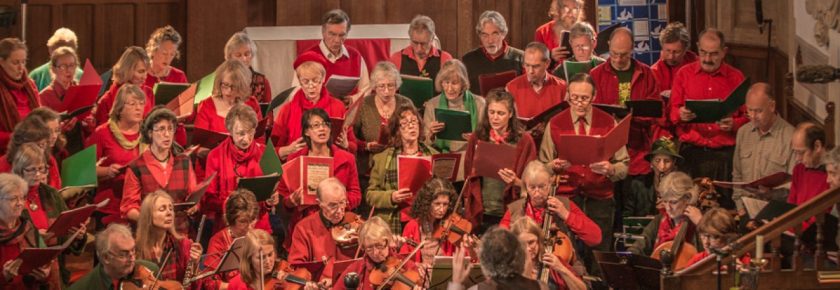 Group performing, dressed in red and green.