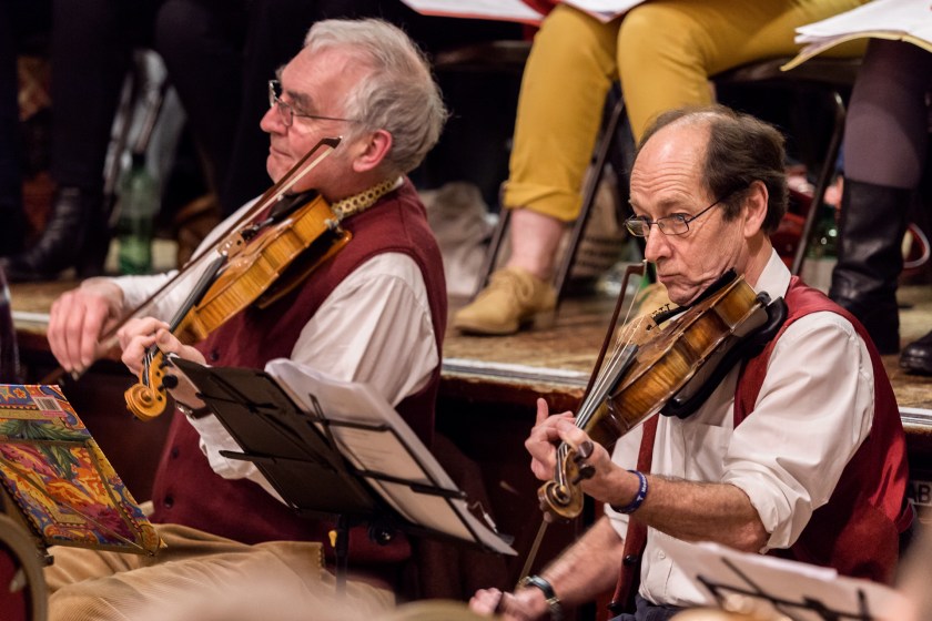 Two men, one playing a violin and one a viola