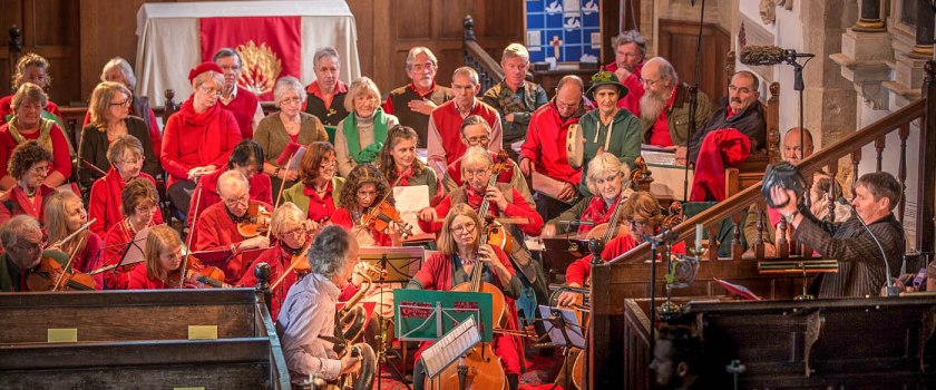 Group of singers and musicians dressed in red