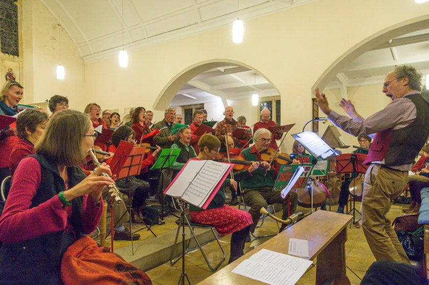 Conductor urgind on the band and singers