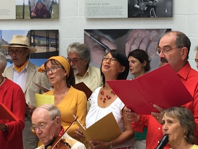 Close up of a few men and women singing