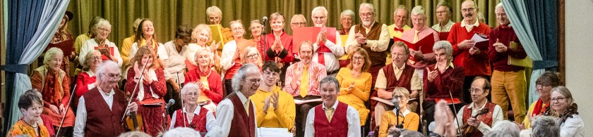 Members of the Ridgeway Singers and Band standing on a stage