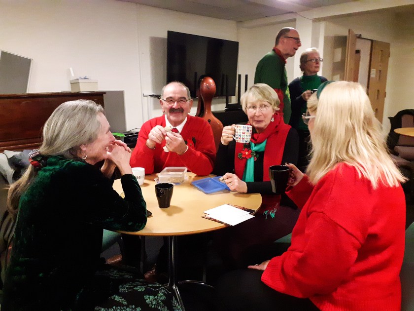 People sitting round a table drinking tea