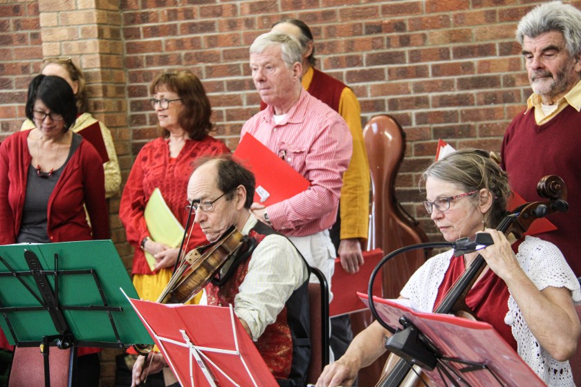 Two musicians backed by singers