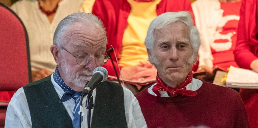 Two men standing at a microphone